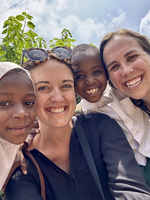 Jessica Bauer, M.D., MUSC pediatric resident, poses with a colleague and local residents during a recent global health project in Tanzania.