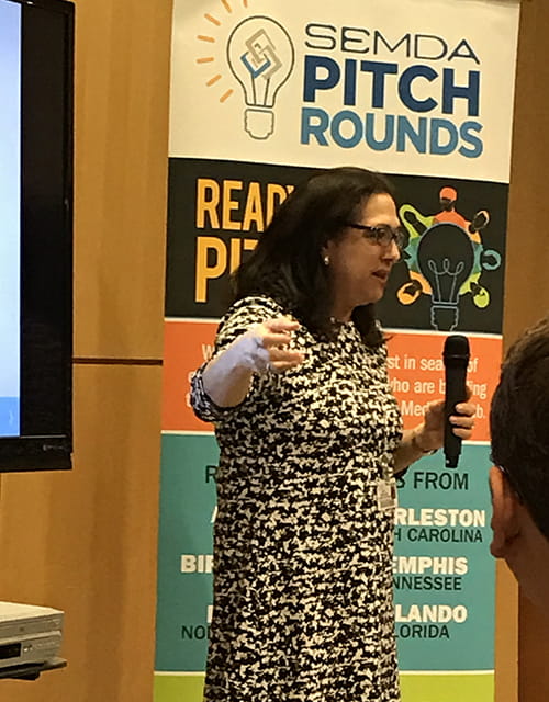 Nancy DeMore speaking on stage