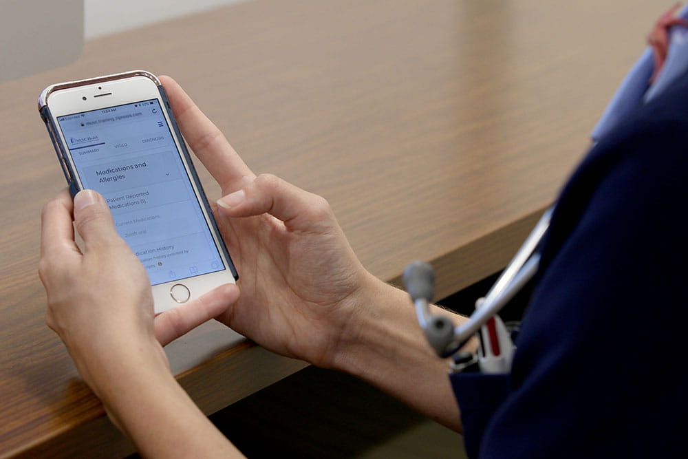 Doctor with smartphone using Virtual Care