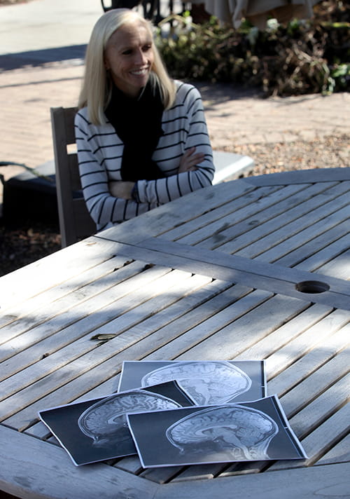 Harriet Farr with the printouts of the triplets' brains spread on a picnic table