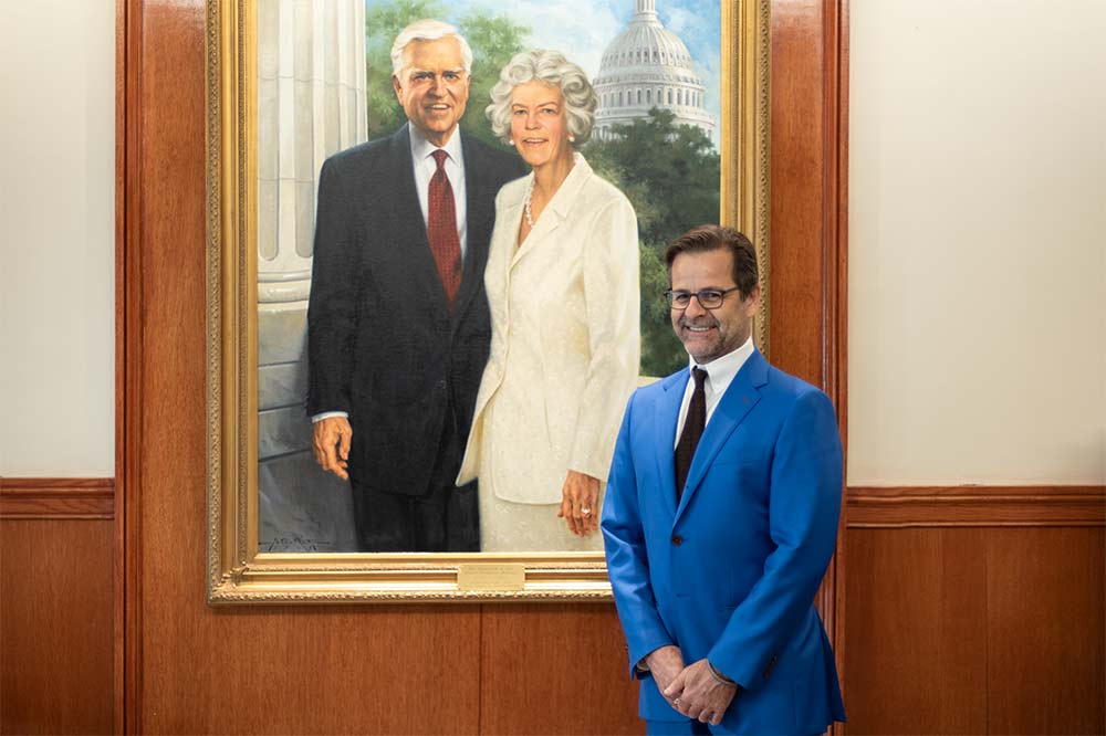 Dr. Gustavo Leone in front of painting